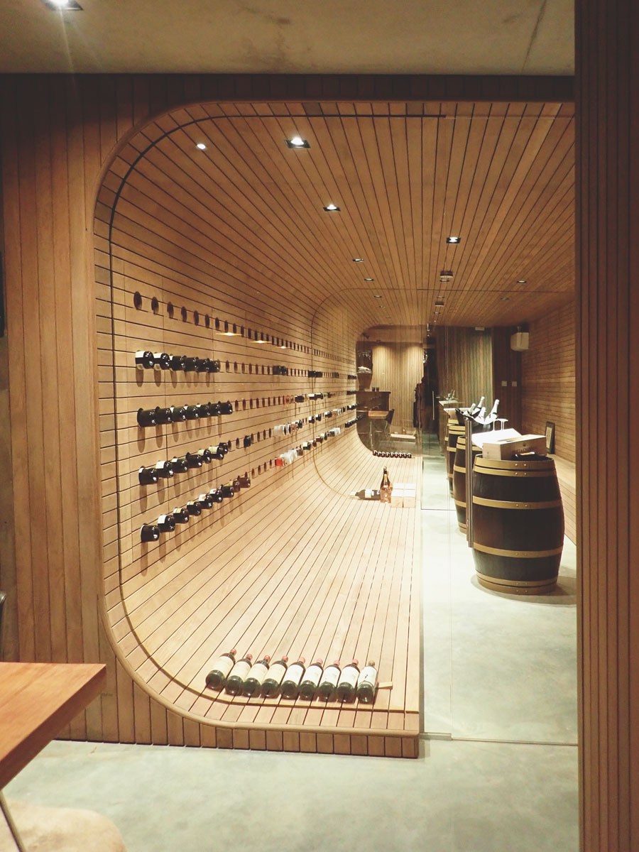 design wijnkelder op maat gemaakt in massief hout met ronde vormgeving